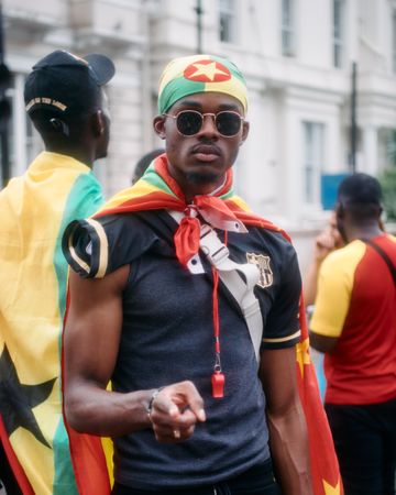 London, England, United Kingdom - August 28, 2022: Man draped in Grenada flag