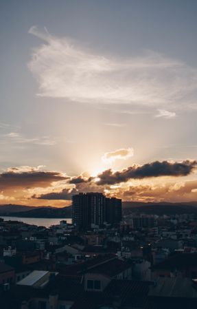 Cityscape near water and beautiful sky in evening