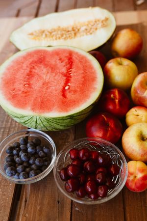 Delicious summer fruits on wooden table