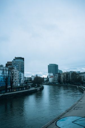 River in Vienna, Austria on overcast day, vertical