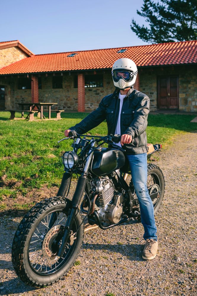 Man with helmet riding custom motorbike