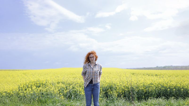 Red haired woman standing in a field