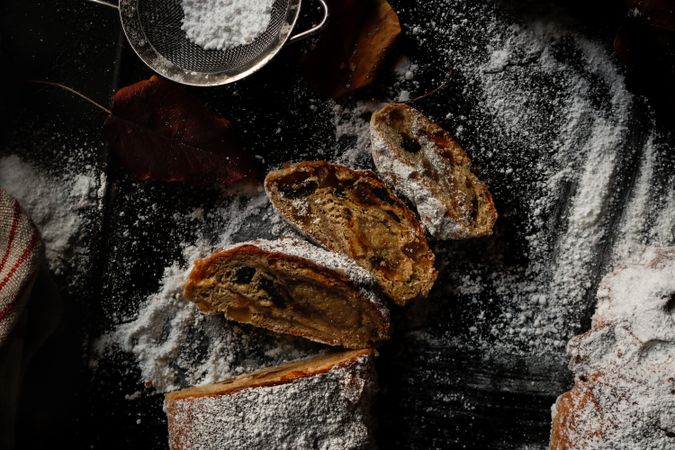 Pieces of Stollen near sieve and autumn leaves