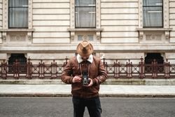Male tourist walking near old building