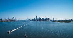 Aerial View of Lower Manhattan Architecture. Panoramic Photo of Wall Street Financial District from a Helicopter. Cityline Scenery with Water Transportation in the Hudson River