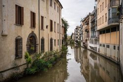 Flooded ancient street among old buildings