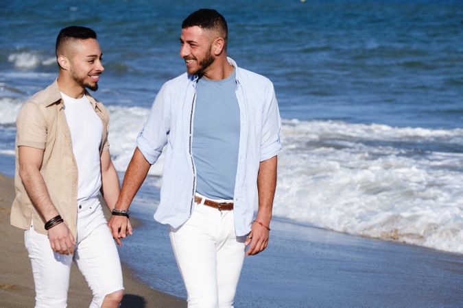 Gay couple walking on beach