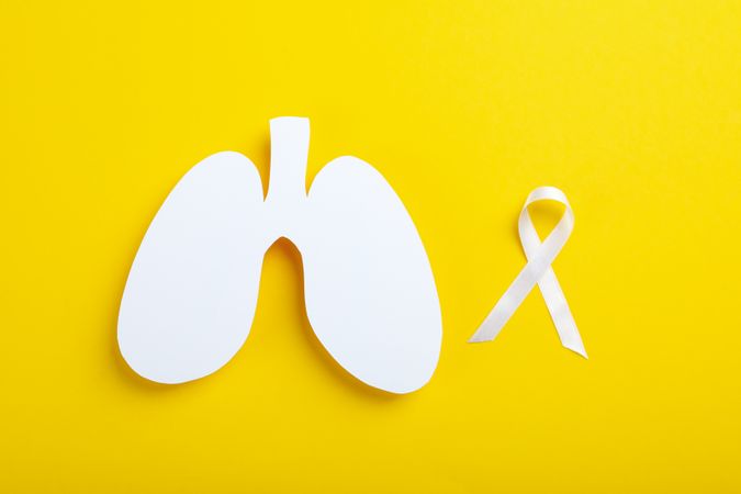 Lung shape with ribbon on yellow background