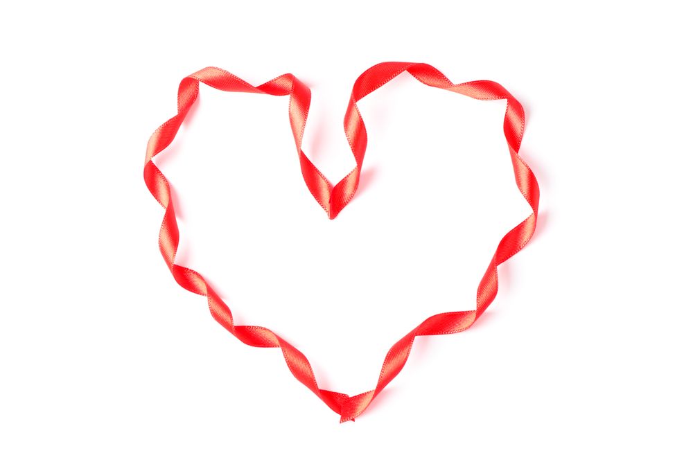 Red ribbon heart isolated on blank background
