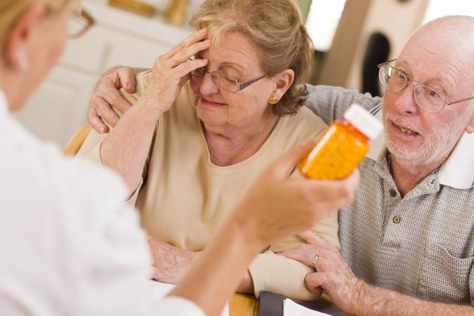 Doctor or Nurse Explaining Prescription Medicine to Older Couple