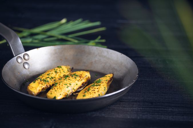 Endives with hollandaise sauce au gratin in pan on table