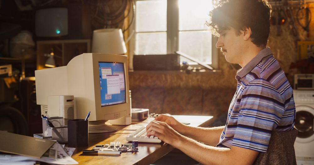 Experienced Software Developer Writing Code For New Innovative Operating System In Nineties.