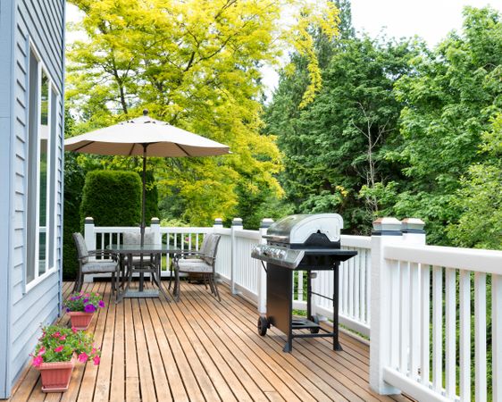 Clean home deck and patio with outdoor furniture and BBQ cooker