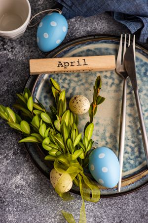 Easter card concept with pastel egg decor and branch adorning table setting
