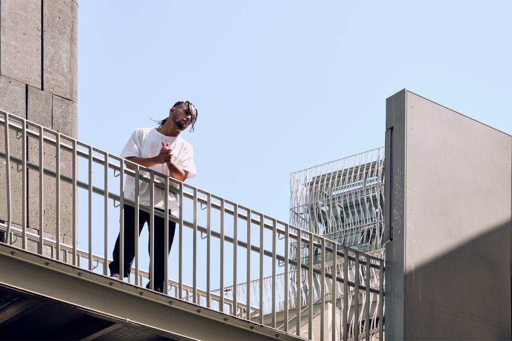 Black male standing on bridge