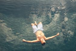 Man swimming in blue water