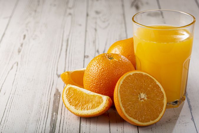 Glass with orange juice on the table.