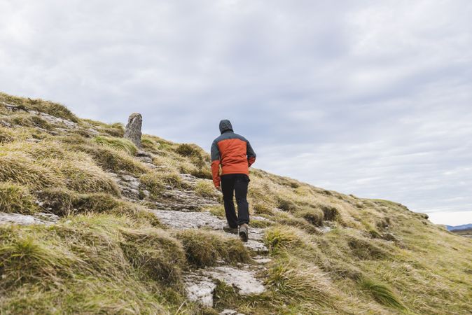 Man walking on hill near valley
