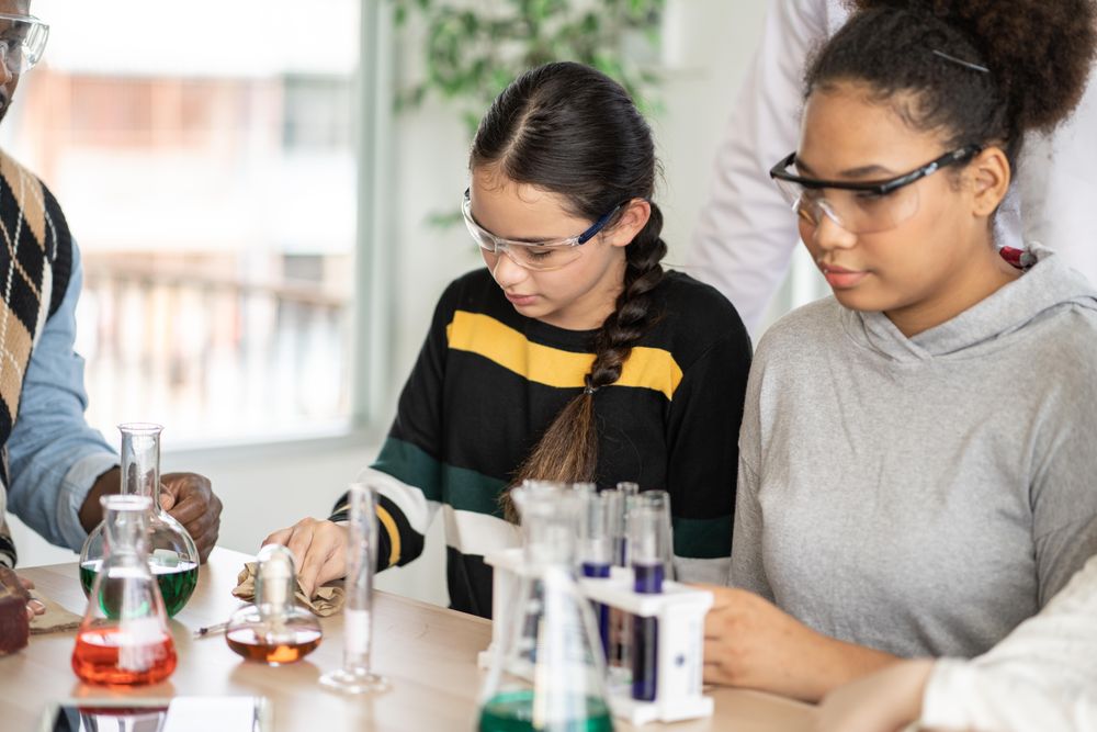 Students in science class doing chemical experiment in laboratory