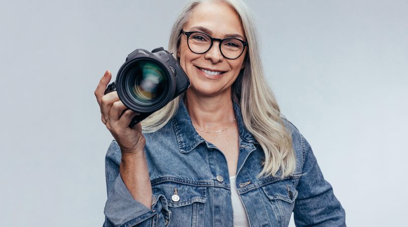 Professional female photographer with digital camera