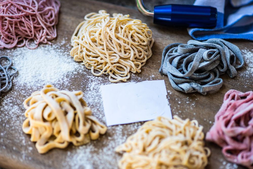 Cooking concept with italian homemade pasta on wooden board