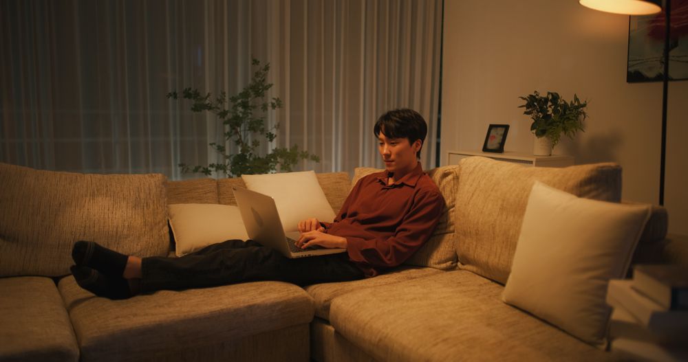 Thoughtful South Korean Professional Working from Home in the Evening
