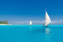 People sailing on a clear day, on clear water