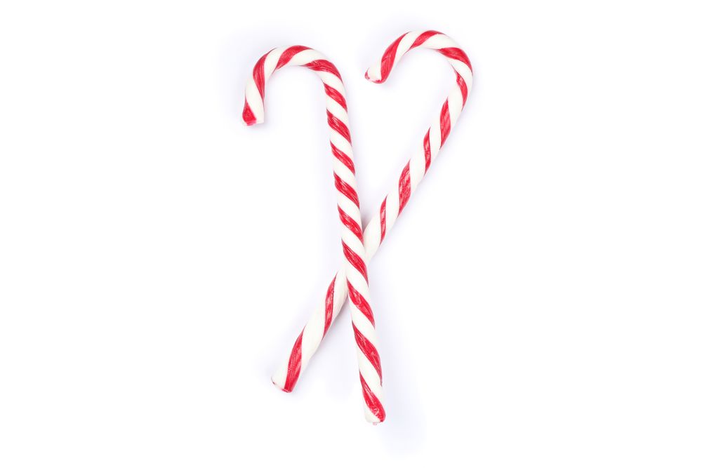 Sweet candy canes isolated on plain background
