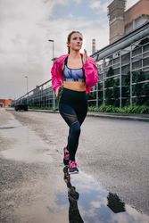 Sportswoman running alone in an industrial zone
