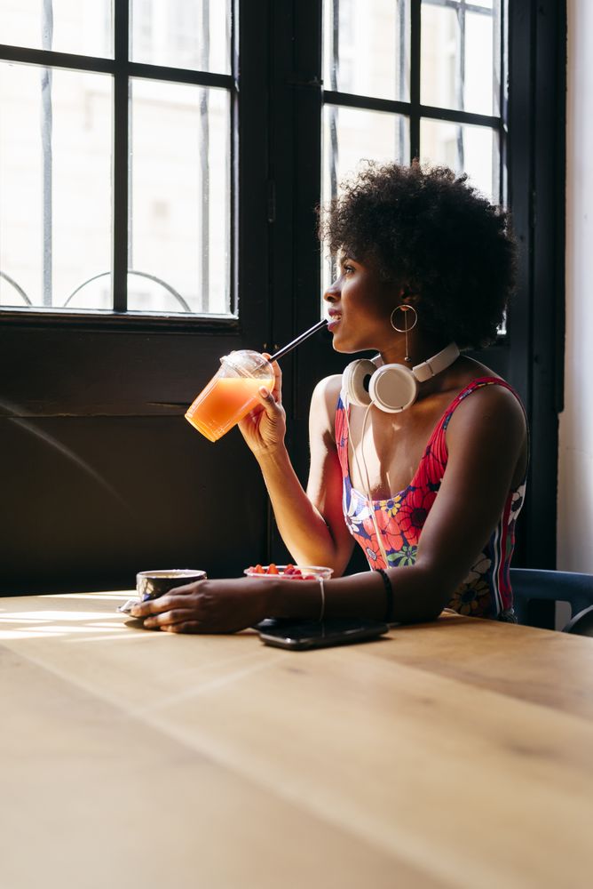 Black woman sipping drink