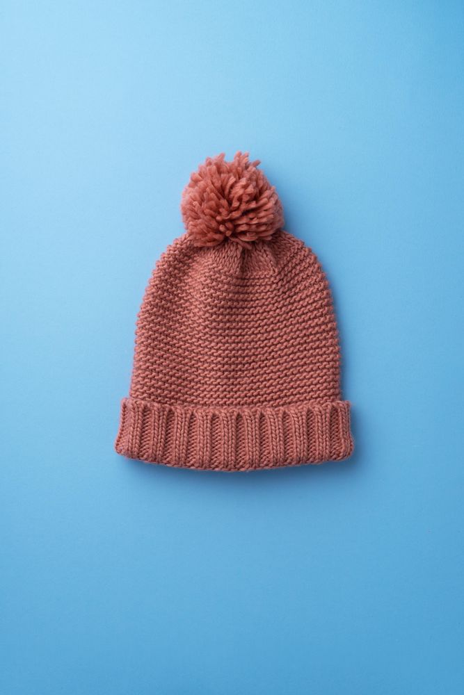 Pink beanie on blue background