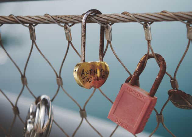 Close up of lovers lock on Maltese chain fence