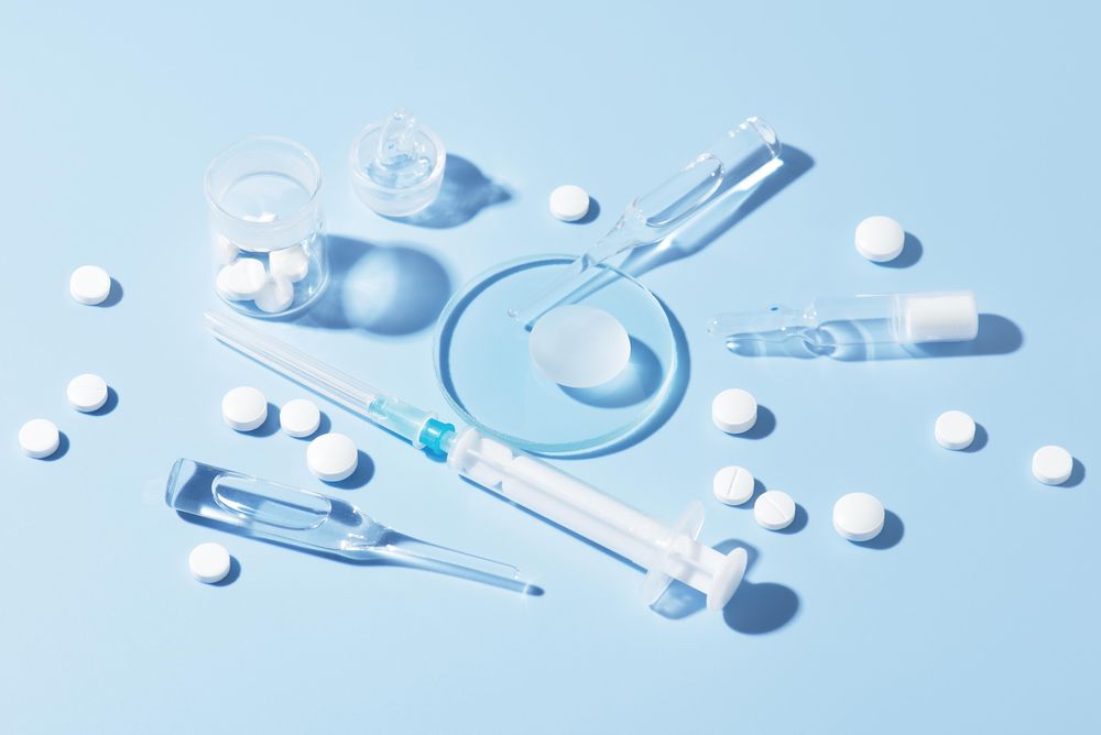 Pharmaceutical drugs on the blue background, concept of complex treatment
