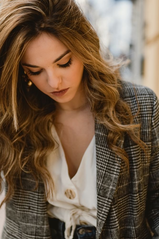 Woman leaning on wall on street