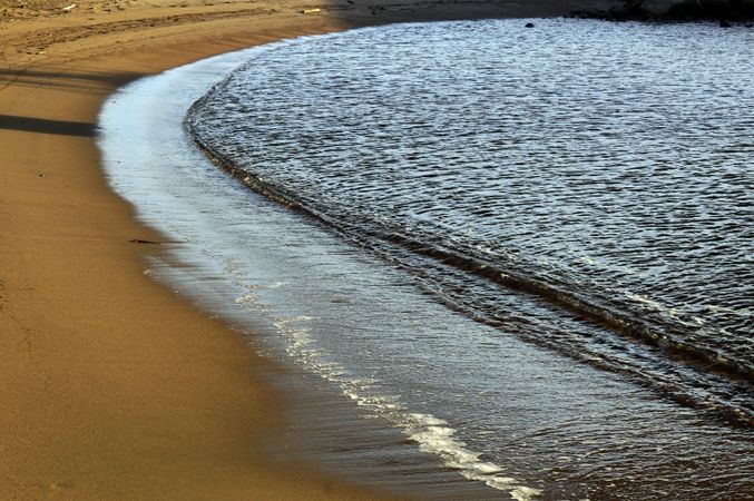 wet sandy shore on sunny day in beach