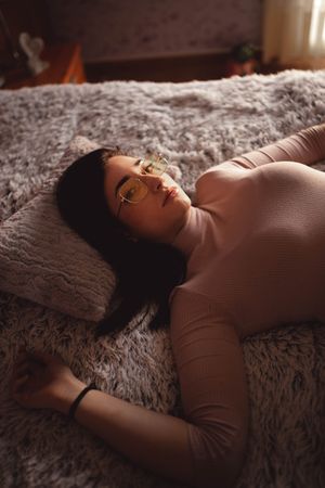 Young woman lying on bed