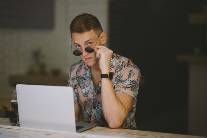 Man working on browsing laptop