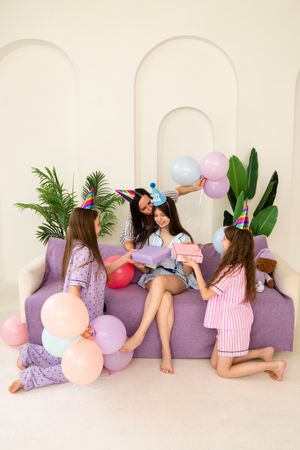 Birthday celebration with friends in pastel pajamas.