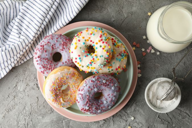Concept of tasty food with donuts and milk on gray background