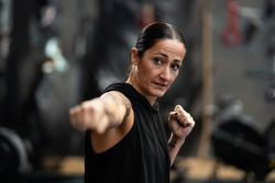 Fit female fighter training in the gym