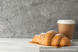 Croissant and paper cup on marble background, copy space 5kJoo0