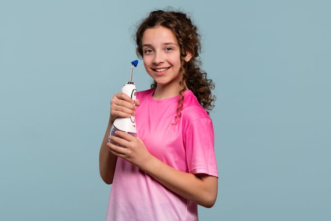 Girl posing with an oral irrigator