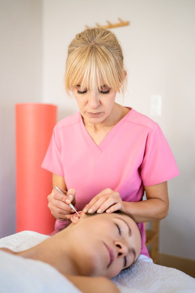 Professional using ear probe pen during skin care treatment in modern beauty salon