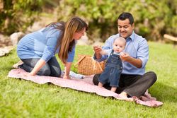 Small Family Playing In The Park