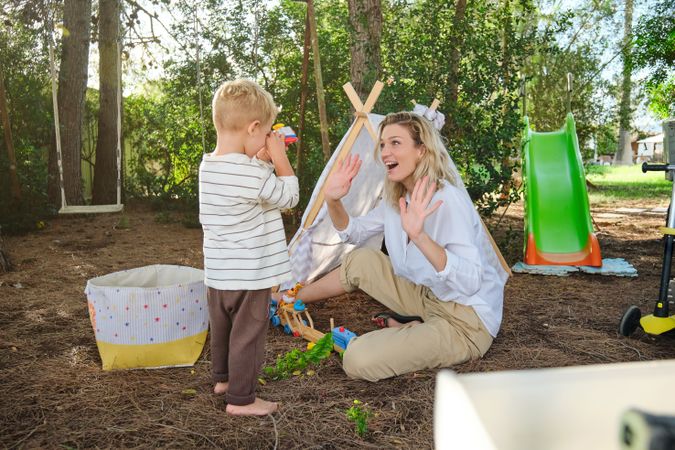 Surprised mother looking at boy in park