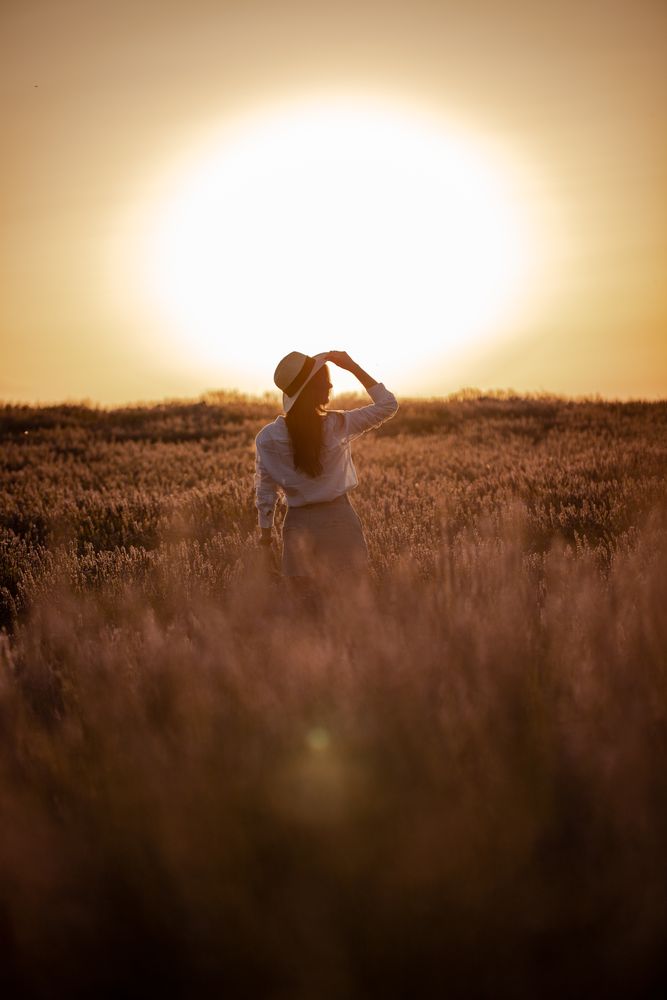 Anonymous woman walking in lavender field