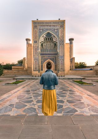 Female tourist in entrance of ornamental building