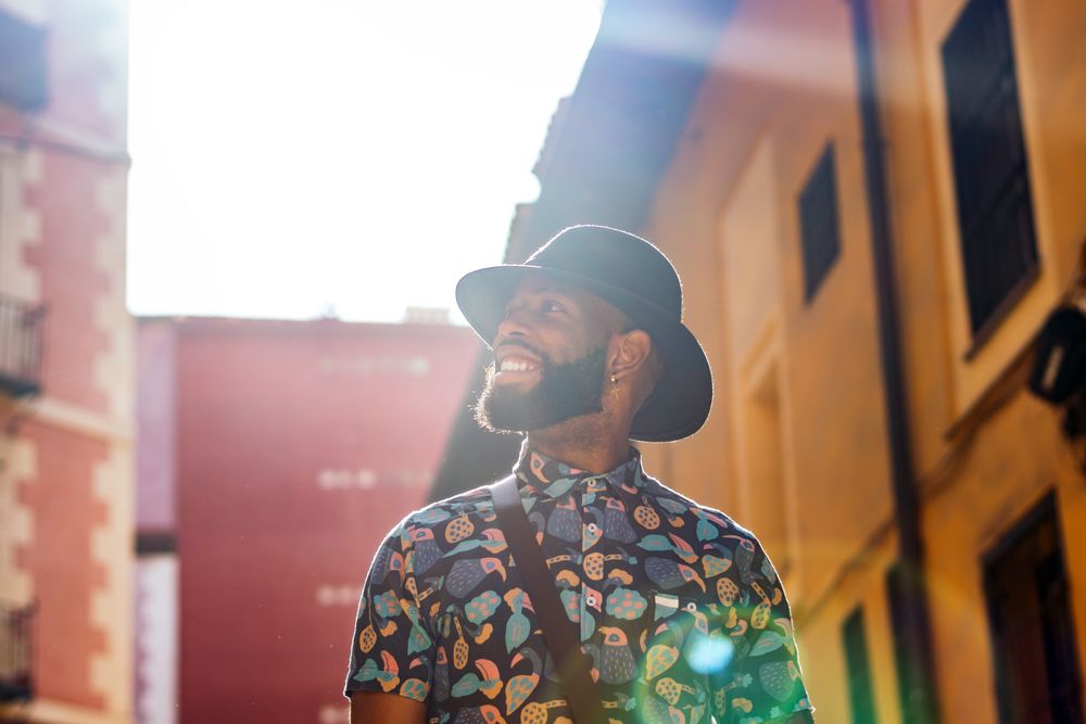 Stylish Black man walking on the city street