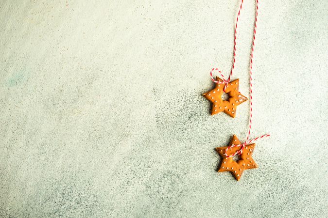 Christmas card concept of 2 star ornaments on concrete counter