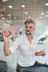 Serious unshaven man creating new mask sample